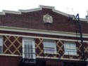 Photo taken Feb. 2018. South end upper detail cartouche. The Empress Apartments Hotel.  Built in 1926 at 16th and Washington.  Current Address in 2017 is 1539-1541 W Burnside. Order #165 Glaze #22M in Leonard Martins order book for Columbia Terra Cotta Co.  The name of the hotel was for a period of time "Marquette Manor"