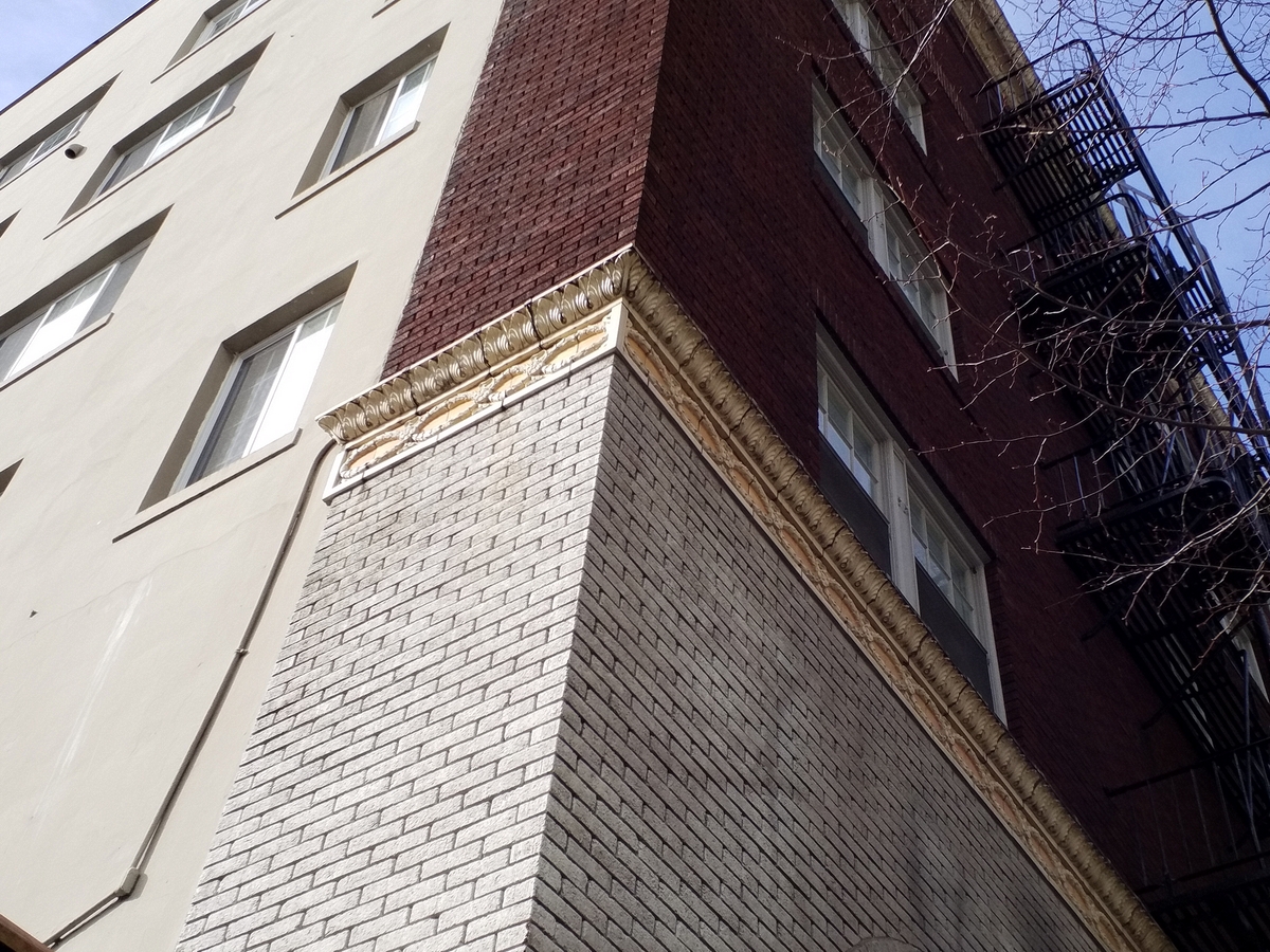 Photo taken Feb. 2018, NE coner detail. The Regency Hotel, at Broadway and Columbia, (1410 S.W. Broadway),  built in 1927.  Architecht: E. J. Pape.  Order #178 Glaze #223 and #402 in Leonard Martins order book for Columbia Terra Cotta Co.  The name of the hotel was for a period of time "St. Andrews Hotel"